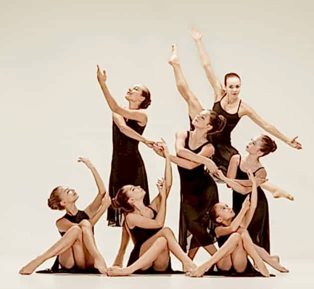 The group of modern ballet dancers The group of modern ballet dancers dancing on gray studio background